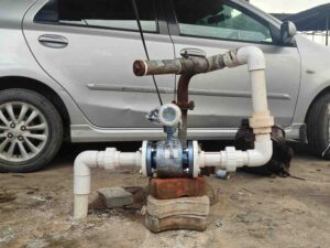 Electromagnetic flow meter being installed on-site for real-time flow monitoring