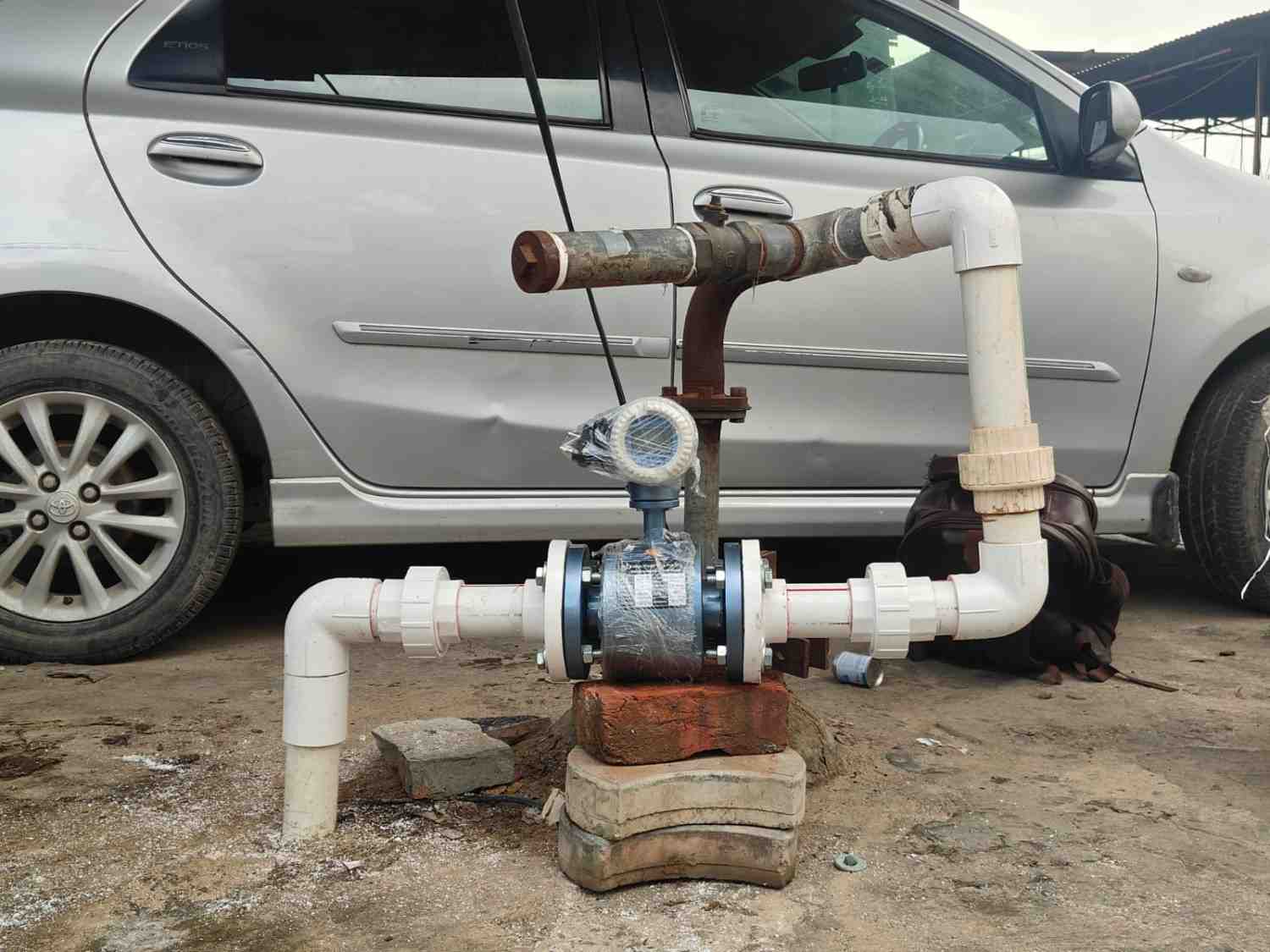 Electromagnetic flow meter being installed on-site for real-time flow monitoring